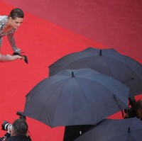 Tak hanya busananya, aksi Kristen Stewart pun nggak kalah nyentriknya. Secara mengejutkan Kristen mencopot heels yang dipakainya di karpet merah sebagai bentuk kritikan. (Foto: Getty Images)