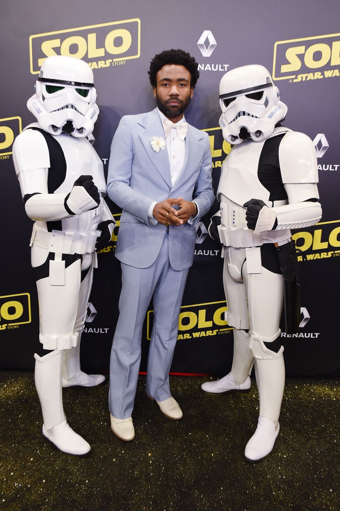 CANNES, FRANCE - MAY 15:  Actor Donald Glover and Stormtroopers attend a 'Solo: A Star Wars Story' party at the Carlton Beach following the film's out of competition screening during the 71st International Cannes Film Festival at Carlton Beach on May 15, 2018 in Cannes, France.  (Photo by Antony Jones/Getty Images for Disney)