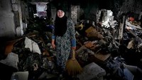 Salah seorang warga Muslim di Filipina, Asnifa Ibrahim sedang menyisir rumahnya yang sudah hancur akibat peperangan antara kelompok militer pemerintah dengan kelompok militan Abu Sayyaf setahun lalu. Asnifa mencoba kembali mengumpulkan barang-barang berharga di runtuhan rumahnya. Jes Aznar/Getty Images.