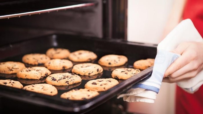 chocolate chip cookies on baking pan hot out of the oven close up