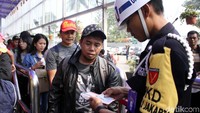 Petugas mengecek tiket calon penumpang.
