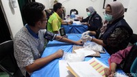 Para sopir memeriksakan kesehatannya. Mereka mengecek tekanan darah dan urine.