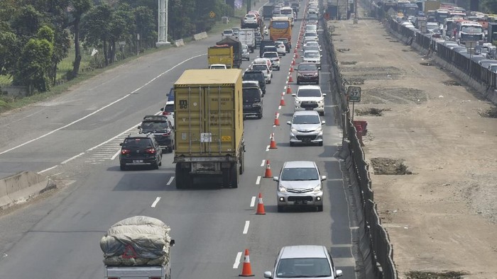 Pengendara mobil melintas di jalur 
