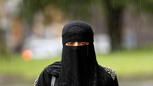 LONDON, ENGLAND - APRIL 11:  A woman wears an  Islamic niqab veil stands outside the French Embassy during a demonstration on April 11, 2011 in London, England. France has become the first country in Europe to ban the wearing of the veil and in Paris two women have been detained by police under the new law.  (Photo by Peter Macdiarmid/Getty Images)