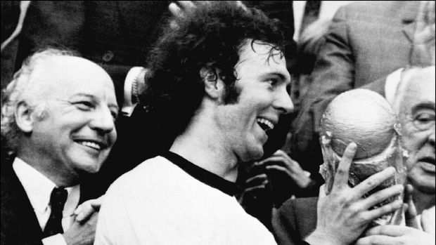 Franz Beckenbauer mengangkat Piala Dunia 1974.