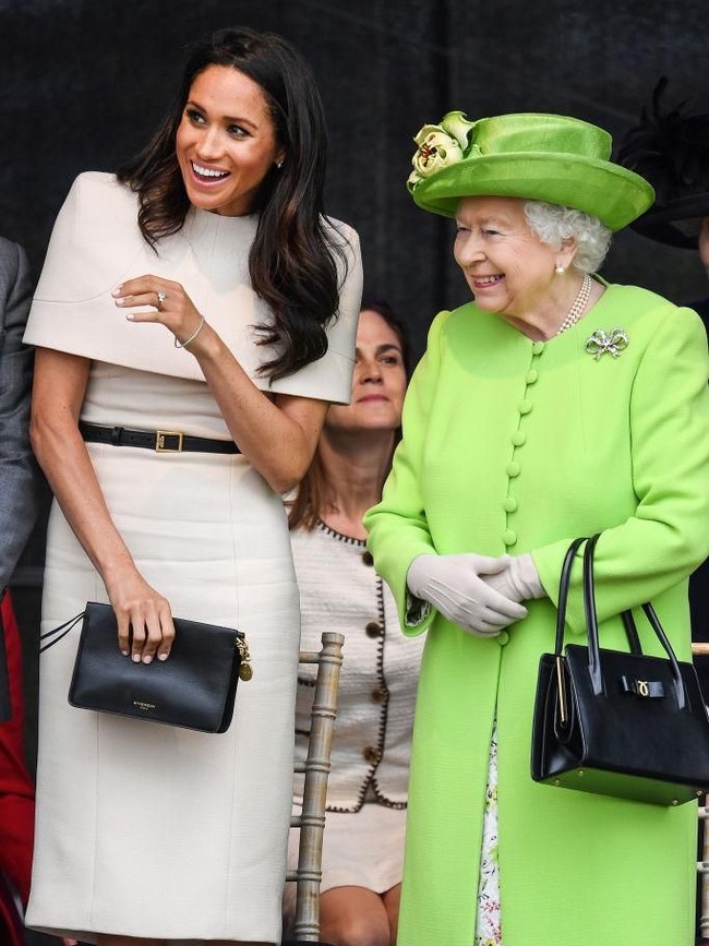 RUNCORN, CHESHIRE, ENGLAND - JUNE 14:  Queen Elizabeth II is greeted with Meghan, Duchess of Sussex as they arrive by Royal Train at Runcorn Station to open the new Mersey Gateway Bridge on June 14, 2018 in the town of Runcorn, Cheshire, England. Meghan Markle married Prince Harry last month to become The Duchess of Sussex and this is her first engagement with the Queen. During the visit the pair will open a road bridge in Widnes and visit The Storyhouse and Town Hall in Chester.  (Photo by Peter Byrne - WPA Pool/Getty Images)