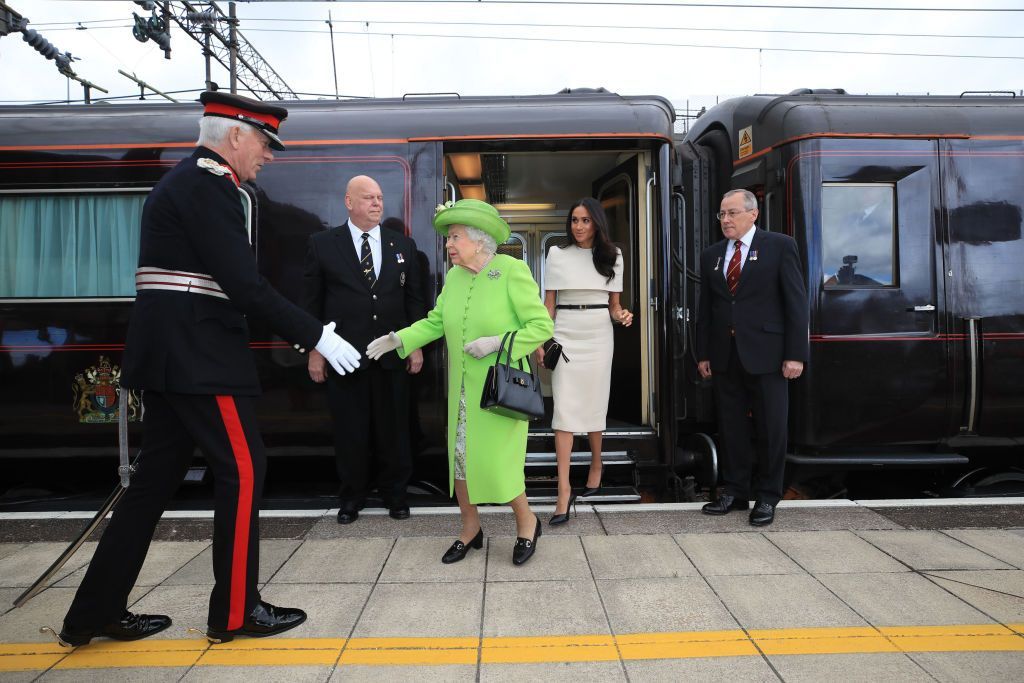RUNCORN, CHESHIRE, ENGLAND - JUNE 14:  Queen Elizabeth II is greeted with Meghan, Duchess of Sussex as they arrive by Royal Train at Runcorn Station to open the new Mersey Gateway Bridge on June 14, 2018 in the town of Runcorn, Cheshire, England. Meghan Markle married Prince Harry last month to become The Duchess of Sussex and this is her first engagement with the Queen. During the visit the pair will open a road bridge in Widnes and visit The Storyhouse and Town Hall in Chester.  (Photo by Peter Byrne - WPA Pool/Getty Images)