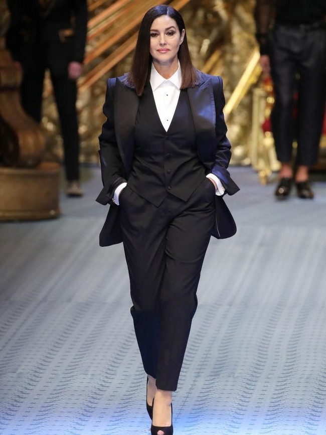 Aktris asal Italia itu tampil dalam balutan setelan hitam bergaya maskulin yang dipadu dengan  peep-toe heels berwarna senada. (Foto: Getty Images)