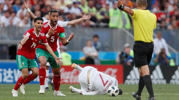 Pemain timnas Maroko Mbark Boussoufa dan Medhi Benatia memprotes keputusan wasit Mark Geiger dalam pertandingan melawan Portugal, di Luzhniki Stadium, Moscow, Russia - June 20, 2018  