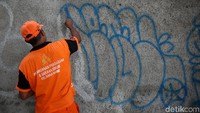 Satu demi satu coretan vandalisme tersebut dibersihkan petugas PPSU.