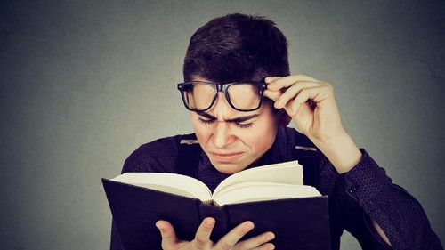 Woman with eyesight problems trying to read on line content in a laptop at home