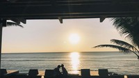 Rayakan honeymoon di Bali, Ricky unggah foto romantis bersama sang istri ketika mereka makan di serbuah restoran dengan pemandangan sunset. Foto: Instagram @komoricky