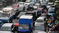 Hujan yang mengguyur sejak pagi, membuat kemacetan semakin parah karena banyak pengendara yang menepi.