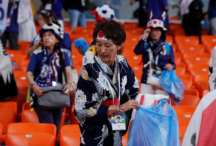 Soccer Football - World Cup - Group H - Japan vs Senegal - Ekaterinburg Arena, Yekaterinburg, Russia - June 24, 2018   Senegal and Japan fans clean up after themselves after the match      REUTERS/Andrew Couldridge