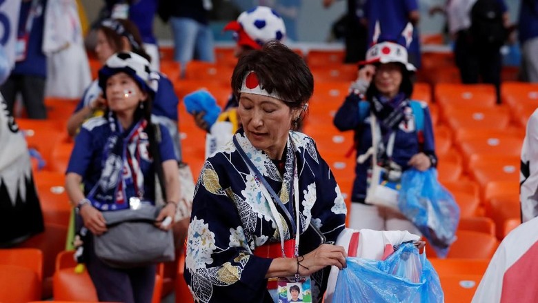 Aksi Simpatik Pendukung Jepang dan Senegal Soccer Football - World Cup - Group H - Japan vs Senegal - Ekaterinburg Arena, Yekaterinburg, Russia - June 24, 2018 Senegal and Japan fans clean up after themselves after the match REUTERS/Andrew Couldridge