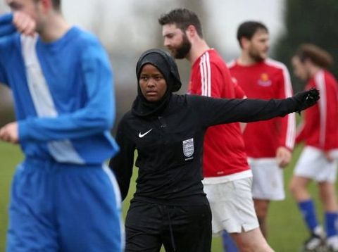 *** EXCLUSIVE - VIDEO AVAILABLE ***  WEMBLEY, UNITED KINGDOM - FEBRUARY 2018: JJ refereeing an all male 11-a-side football match in Wembley, England.  CONDITION OF USAGE: The following must be included in print and/or online: JJ?s story will feature in The History of Football global TV event, airing on History (excluding USA, Canada, Australia, New Zealand), from May 28th-10th June 2018. AS her first full season as a Football Association-registered official draws to a close, Jawahir Roble has made history as the first Muslim female referee in the UK. Having always loved football, JJ made the decision to pursue refereeing more seriously after studying for coaching badges as a teenager. A local girl?s league was short of match officials and JJ stepped in, eventually going on to do a refereeing course. JJ?s love of the beautiful game goes back to her childhood. Among the rubble of the Mogadishu streets, JJ would play football with her friends and siblings. Pleading with her parents to stay out beyond their curfew so she could play football for longer, JJ wasn?t so much oblivious to the dangers of war as conditioned to it. JJ?s incredible story will feature in The History of Football global TV event, airing on History (excluding USA, Canada, Australia, New Zealand), from May 28th-10th June 2018.  PHOTOGRAPH BY Barcroft Images / HISTORYÆ