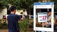 Seorang personel polisi tak mau menyia0nyiakan kesempatan untuk ikut berfoto.