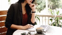 Sedang asyik buka laptop, Ana ditemani secangkir kopi di sampingnya. Wah, suka ngopi juga nih! Foto: Instagram anaoctarina