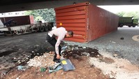 Seorang polisi sedang menyisir area kecelakaan.