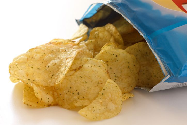Blue packet of crisps with cheese and spring onion flavour