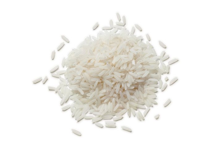 Heap of raw Jasmine rice on white background