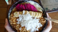 Smoothies dengan taburan granola, kelapa, pisang dan buah naga jadi santapan Erica. Sehat dan mengenyangkan pastinya. Foto: Instagram ericaputrii