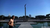 Patung Monumen Pembebasan Irian Barat tampak gagah menjulang diantara taman dan air mancur.