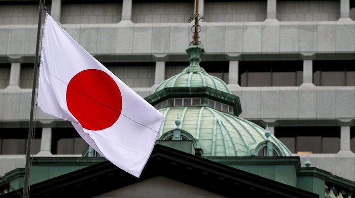 FILE PHOTO: A Japanese flag flutters atop the Bank of Japan building in Tokyo, Japan, September 21, 2016.