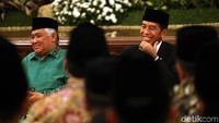 Mengenakan kemeja putih polos berbalut jas hitam dan peci, Jokowi duduk berhadapan dengan para ulama dan santri.