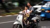 Hari pertama masuk sekolah membuat orang tua murid memilih mengantarkan langsung anak mereka ke sekolah. Namun sayangnya masih ada saja pengendara motor yang tak mengenakan helm dan membahayakan diri saat berkendara di jalan besar.