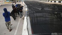 Penutupan dilakukan agar warna air kali yang hitam tidak mengganggu para atlet yang menginap di wisma tersebut.