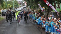Mereka memenuhi sisi jalan untuk menyambur obor tersebut.