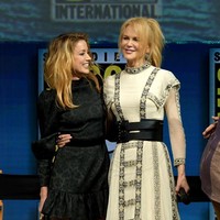 Lawan main Nicole, aktris Amber Heard juga tak kalah modis. Gaun hitam beraksen ruffle menjadi pilihannya. (Foto: Getty Images)