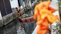 Seorang petugas Unit Pengelolaan Kebersihan (UPK) Badan Air terlihat sedang membersihkan sungai Warakas, Jakarta Utara, Selasa (24/7/2018).