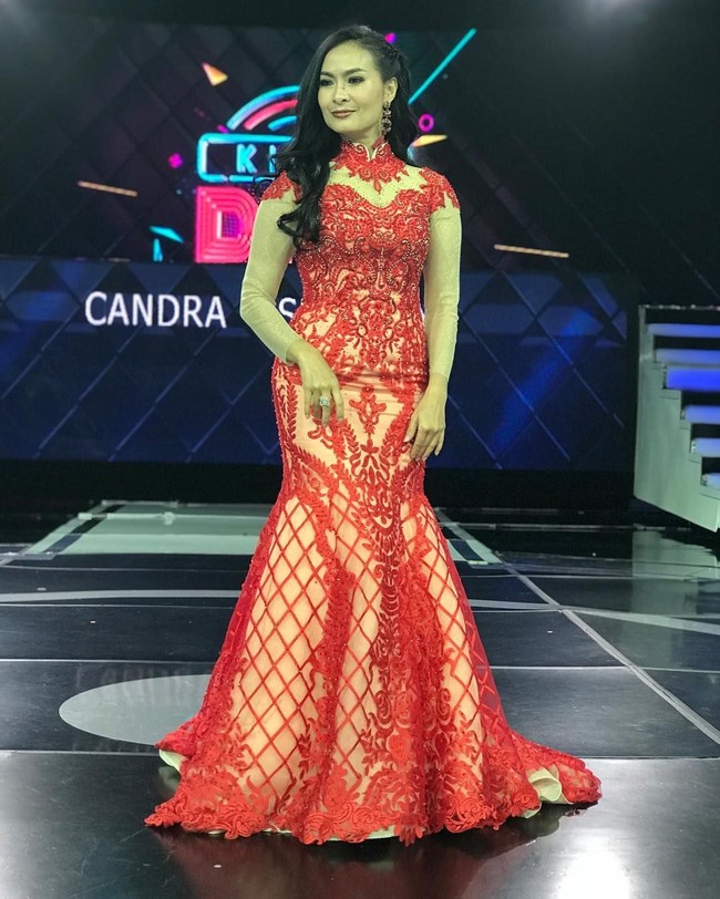 Gaun merah berpotongan mermaid dan detail lace yang menghiasi hampir seluruh busana membuat penampilan Iis Dahlia tampak glamour. Foto: Instagram @ isdadahlia