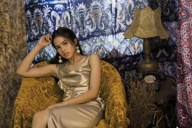 Tampil glamor dan seksi dalam balutan gaun emas. Potongan gaun yang simpel jadi lebih semarak dengan tambahan aksesori anting mutiara oversized. Foto: Dok. detikhot