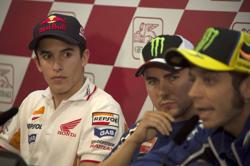 VALENCIA, SPAIN - NOVEMBER 07:  Marc Marquez of Spain and Repsol Honda Team (L) and Jorge Lorenzo (C) of Spain and Yamaha Factory Racing look on as Valentino Rossi of Italy and Yamaha Factory Racing speaks during the press conference pre-event during the MotoGP of Valencia previews at Ricardo Tormo Circuit on November 7, 2013 in Valencia, Spain.  (Photo by Mirco Lazzari gp/Getty Images)