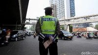 Polisi memantau kendaraan yang melintas di kawasan ganjil-genap.