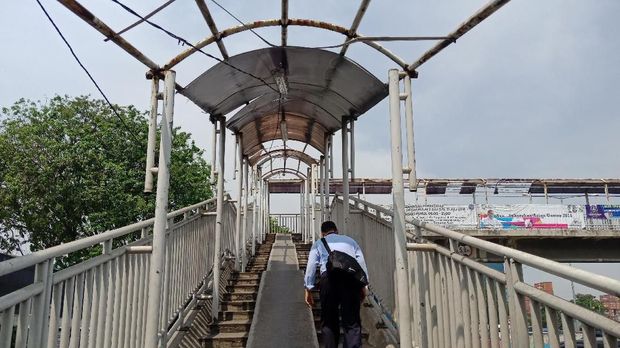Warga berjalan di JPO Ampera yang tak terawat