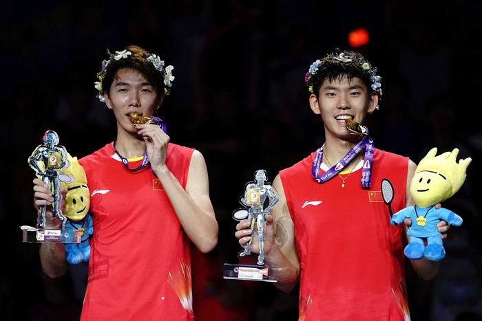 NANJING, CHINA - AUGUST 05: Li Junhui and Liu Yuchen of China celebrate on the podium after winning the mens doubles final defeatingTakeshi Kamura and Keigo Sonoda of Japan on day 7 of Total BWF World Championships at Nanjing Youth Olympic Games Sport Park on August 5, 2018 in Nanjing, China.  (Photo by Lintao Zhang/Getty Images)