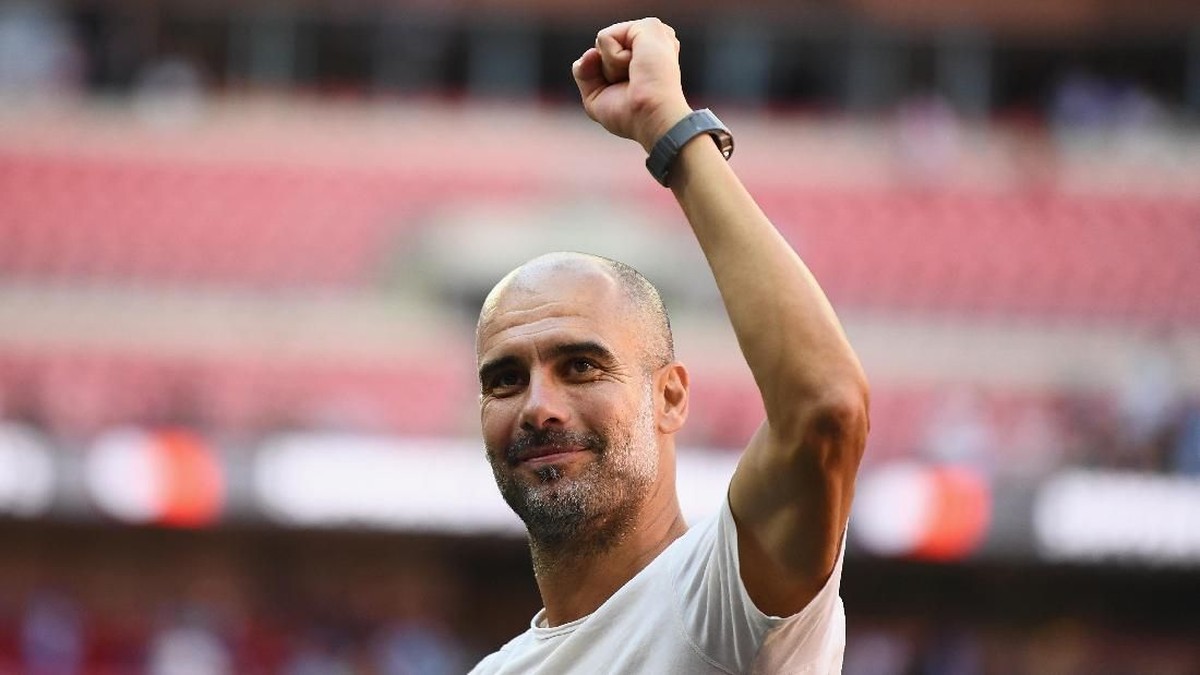 Pep Guardiola punya keinginan untuk melatih tim nasional (Foto: Clive Mason/Getty Images)