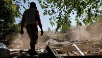 Seorang warga melihat rumahnya yang hancur akibat gempa, Selasa (7/8). REUTERS/Beawiharta.