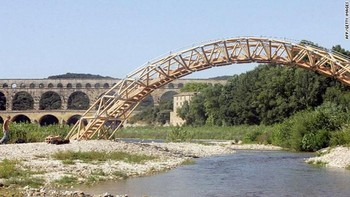 Arsitek Jepang, Shigeru Ban membuat jembatan dari kardus yang melintasi Sungai Gardon di Prancis. Walaupun terbuat dari kardus, jembatan ini mampu menahan beban 20 orang dewasa. (Fot: geek.com)