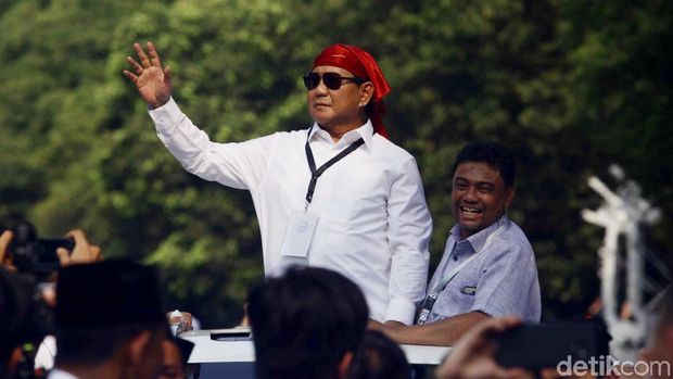 Prabowo menyapa pendukung dari sunroof mobil.