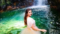 Ashanty saat melakukan sesi foto di kolam dengan pemandangan air terjun. Foto: Dok. Instagram/ashanty_ash