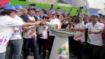 Potret Meriahnya Arak-arakan Obor Asian Games di Jakarta