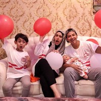 Fairuz A. Rafiq tampil kompak dengan keluarganya. Mereka memakai kaos putih dengan garis merah. Namun, ia menyisipkan warna netral nan gelap seperti hitam dan abu agar tak terlihat terlalu menonjol. (Foto: Instagram)