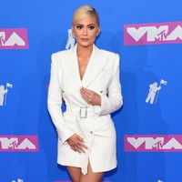 Kylie Jenner tampil mengenakan trench coat dress warna putih berpotongan tailoring di ajang penghargaan MTV VMAs 2018. Busana tersebut datang dari brand Tom Ford. Foto: Getty Images