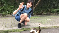 Saat trip ke Jepang, Hyo Jin iseng berfoto dengan seekor kucing jalanan yang asyik jilat-jilat ekornya. (Instagram/@hjyang14v)