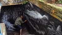 WD saat sedang mengerjakan mural karya seninya. Istimewa/Boredpanda.